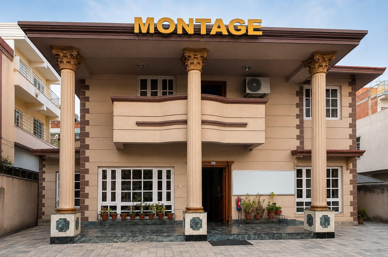 The Montage Overseas office in Kalanki, Kathmandu — a two-storey beige building fronted by three fluted Corinthian columns on green marble plinths, with a curved first-floor balcony, white-framed windows and gold MONTAGE lettering on the fascia above the entrance